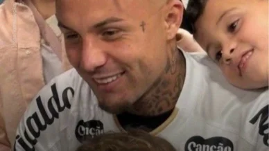 Cebolinha veste a camisa do Santos após desembarque em aeroporto